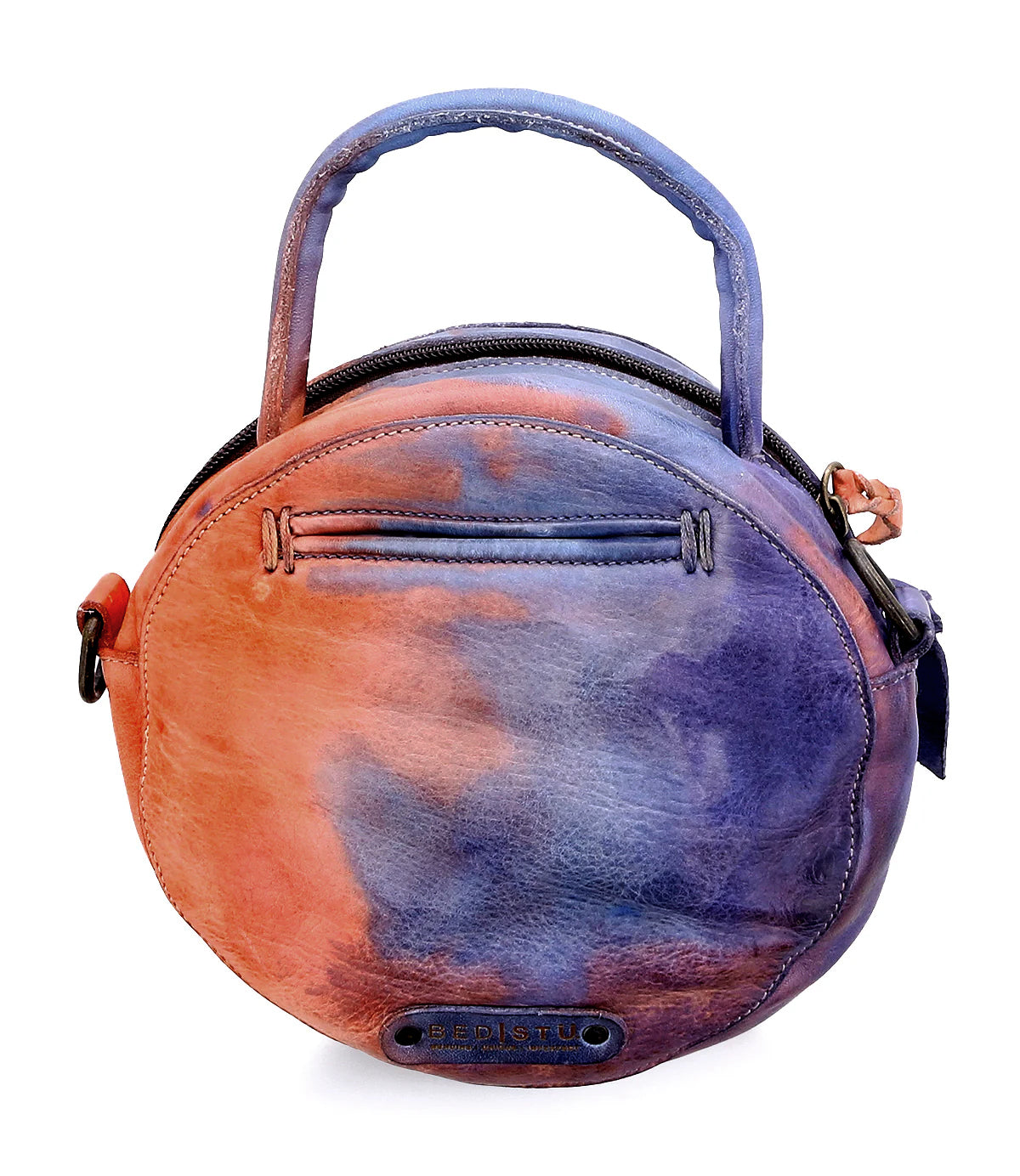 The Arenfield by Bed Stu is a round crossbody handbag with a short handle, an adjustable strap, zippered front pocket, orange, blue, and purple tones, and a small metal "BED STU" label.