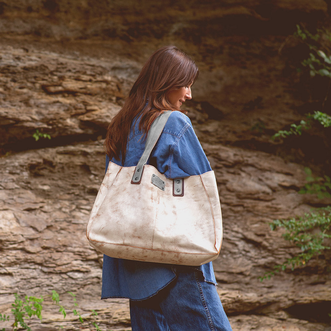 Woman wearing a white custom made handbag.