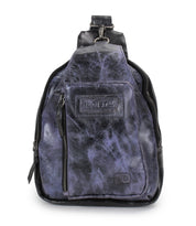 The Beau by Bed Stu is a small, distressed black and purple leather sling backpack with a front zipper pocket, top handle, and stitched logo patch—ideal for hands-free convenience.