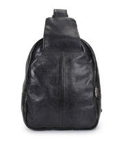 The Bed Stu Beau is a black leather sling backpack with a front pocket and single wide strap, shown upright against a white background.