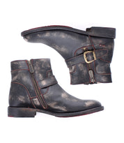 The Bed Stu Becca is a pair of distressed black short engineer boots with dual zippers, ankle buckles, and straps, shown in a side view on a white background.