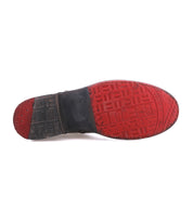 The Bed Stu Becca features a textured red and black rubber sole with multiple grip patterns, echoing the durability and style of a short engineer boot.