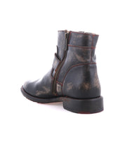 The Becca by Bed Stu is a single worn black leather short engineer boot featuring dual zippers and brown scuff marks, shown on a white background.