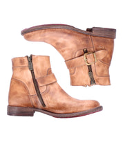 The Bed Stu Becca is a pair of brown leather short engineer boots with dual zippers, ankle buckles, and low heels, displayed from the side against a white background.