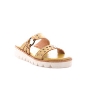 The Bed Stu Chow sandal features tan distressed leather, studded straps, a metal buckle, cushioned footbed, and a thick white chunky rubber sole, shown against a plain white background.