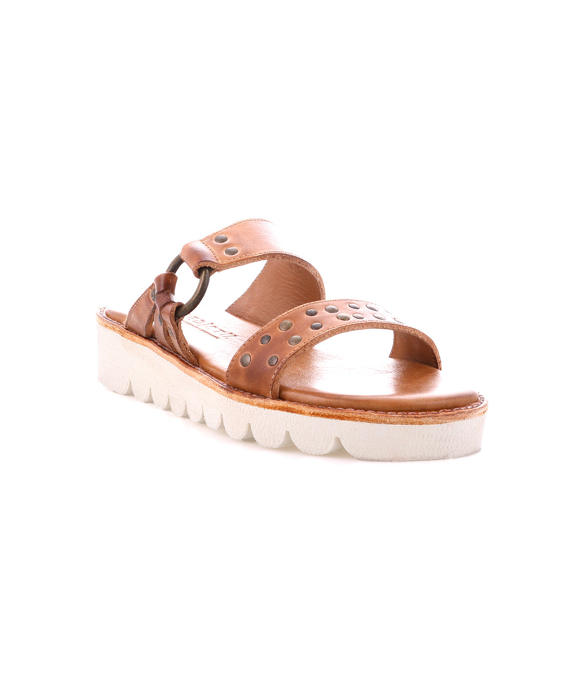 The Chow sandal by Bed Stu features distressed leather and two straps with metal rivets, a chunky white ridged sole, and a cushioned footbed for ultimate comfort.