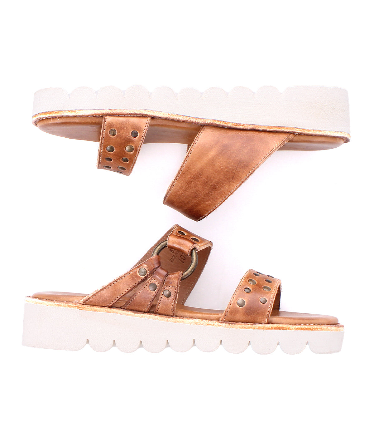Bed Stu's Chow sandals feature brown leather with stud details and chunky rubber soles, showcased on a mirrored white background.