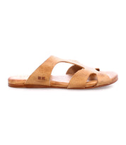 A tan slip-on leather sandal with a flat sole and crisscross design, featuring a cushioned inner sole, viewed from the side—this is the Configure by Bed Stu.