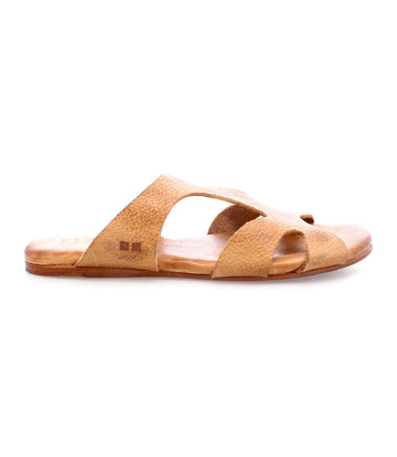 A tan slip-on leather sandal with a flat sole and crisscross design, featuring a cushioned inner sole, viewed from the side—this is the Configure by Bed Stu.