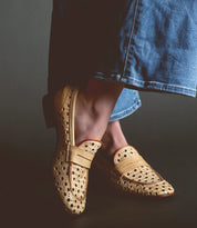 Person wearing tan Cornflower slip-on shoes handcrafted in Italy by Bed Stu and blue denim pants.