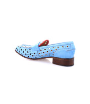 Cornflower penny loafer by Bed Stu featuring light blue perforated leather with a playful circular cutout pattern, red accent on the tongue, and wooden heel, viewed from the side. Handcrafted in Italy for elegant style and comfort.