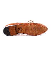 The image shows the sole of a Bed Stu Decoy with bold square cutouts and visible stitching. It features a heel made of different material and playful lace-up derby design. There is also a size marking and text printed on the sole, indicating it was handcrafted in Italy.