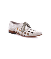 A stylish, handcrafted-in-Italy white lace-up Decoy derby from Bed Stu with bold square cutouts on the sides, a brown sole, and a slight heel.