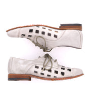 A pair of playful Decoy lace-up derby shoes by Bed Stu in light gray, featuring bold square cutouts on the sides, wooden heels, and vibrant orange soles. Handcrafted in Italy for exceptional quality and style.