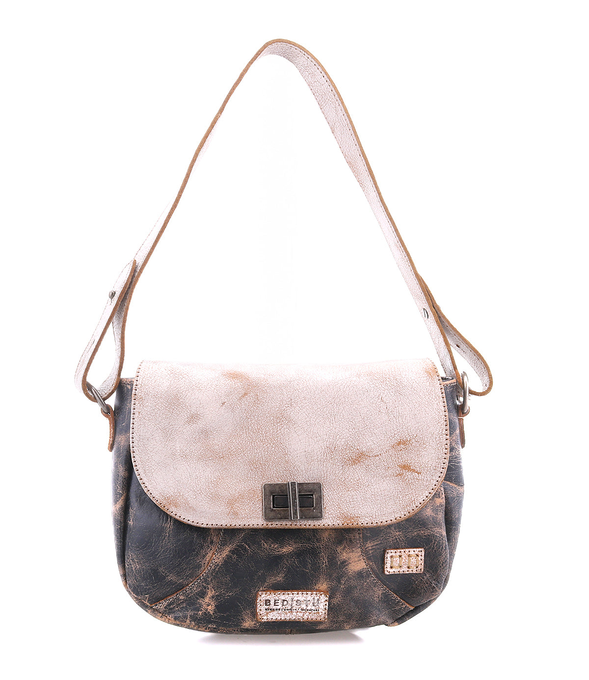 The Bed Stu Elect is a two-tone shoulder bag featuring a light beige flap, dark brown body, metal clasp, and adjustable strap, exuding vintage charm and displayed elegantly against a white background.
