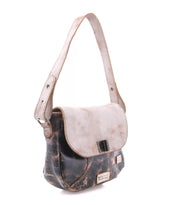 The Bed Stu Elect is a vintage-inspired shoulder bag featuring two-tone leather—a distressed dark brown body, light beige flap, adjustable strap, and buckle closure—displayed on a white background.