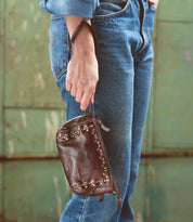 A woman is holding an Encase leather bag by Bed Stu.
