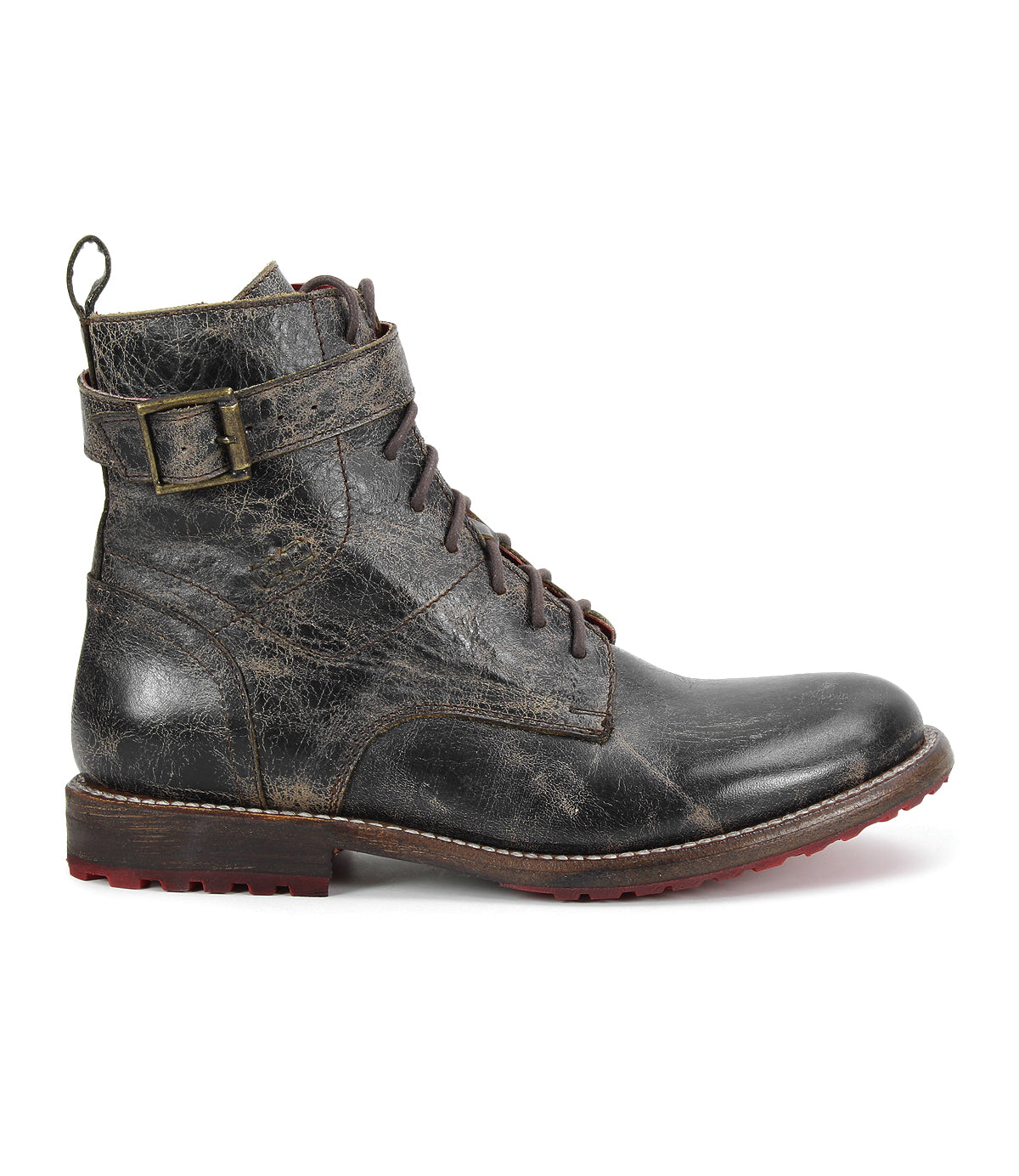 The Bed Stu Endure is a single worn black lace-up ankle boot featuring a decorative buckle on the side and a red rubber outsole, displayed in profile against a white background.