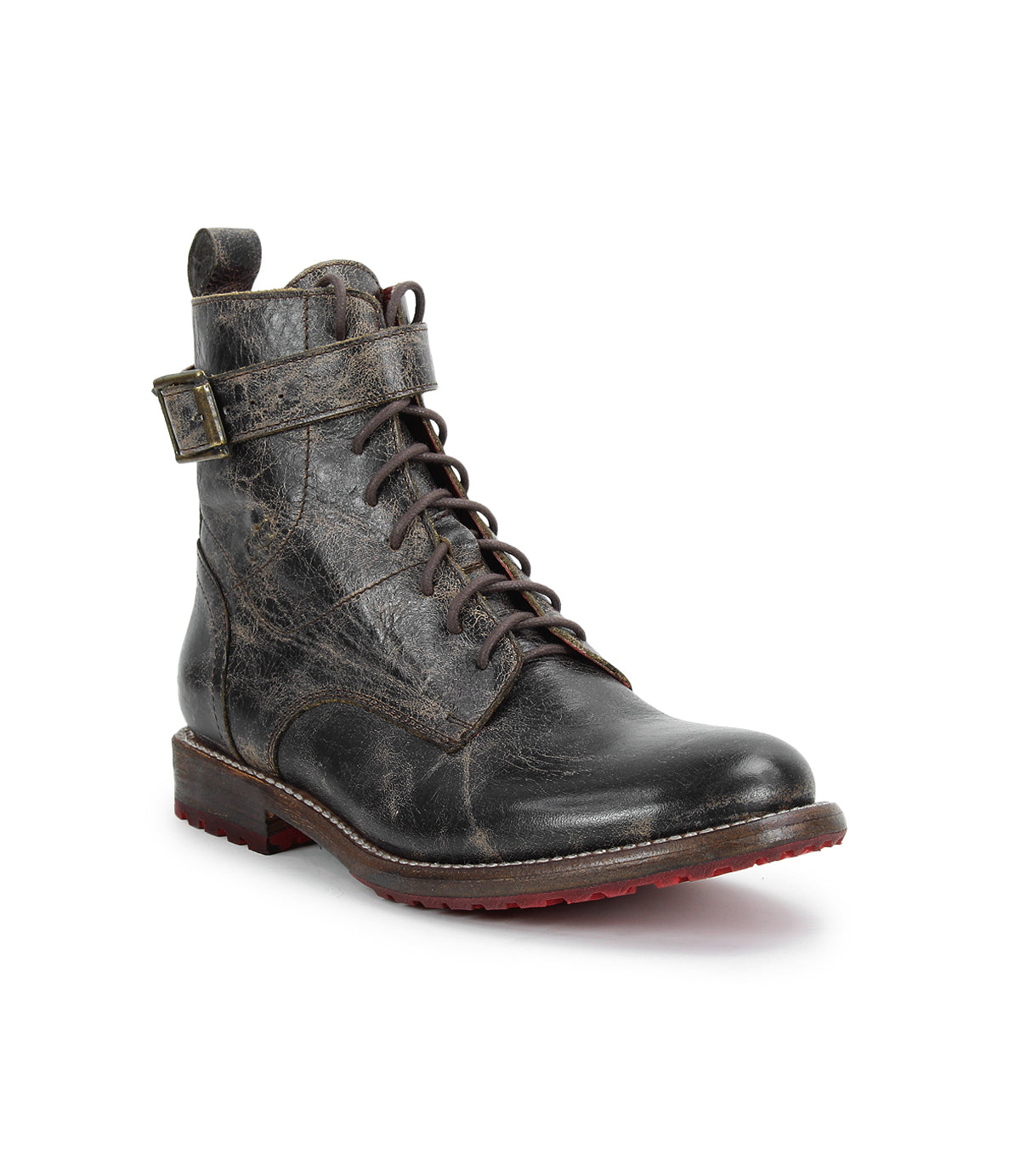 The Bed Stu Endure is a black lace-up ankle boot with a side buckle strap, rugged texture, leather lining, and a bold red rubber outsole, displayed on a white background.