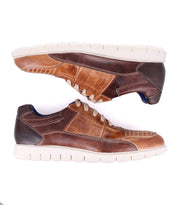 Two Fairman low-top leather sneakers by Bed Stu, featuring unique topstitching and perforated sides with a 3-tone brown finish and white soles, viewed from the side with toes facing opposite directions.