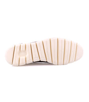 The image features the sole of a low-top leather sneaker from Bed Stu's Fairman collection. It has large, rectangular treads on a primarily white, 3-tone finish. "Geox" is marked in small lettering, highlighting its sleek and modern design.