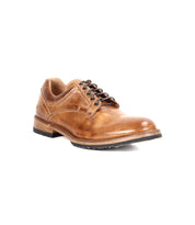 The Bed Stu Fierce is a brown leather men’s derby shoe with a classic design, low heel, and black sole that adds modern edge, shown against a white background.