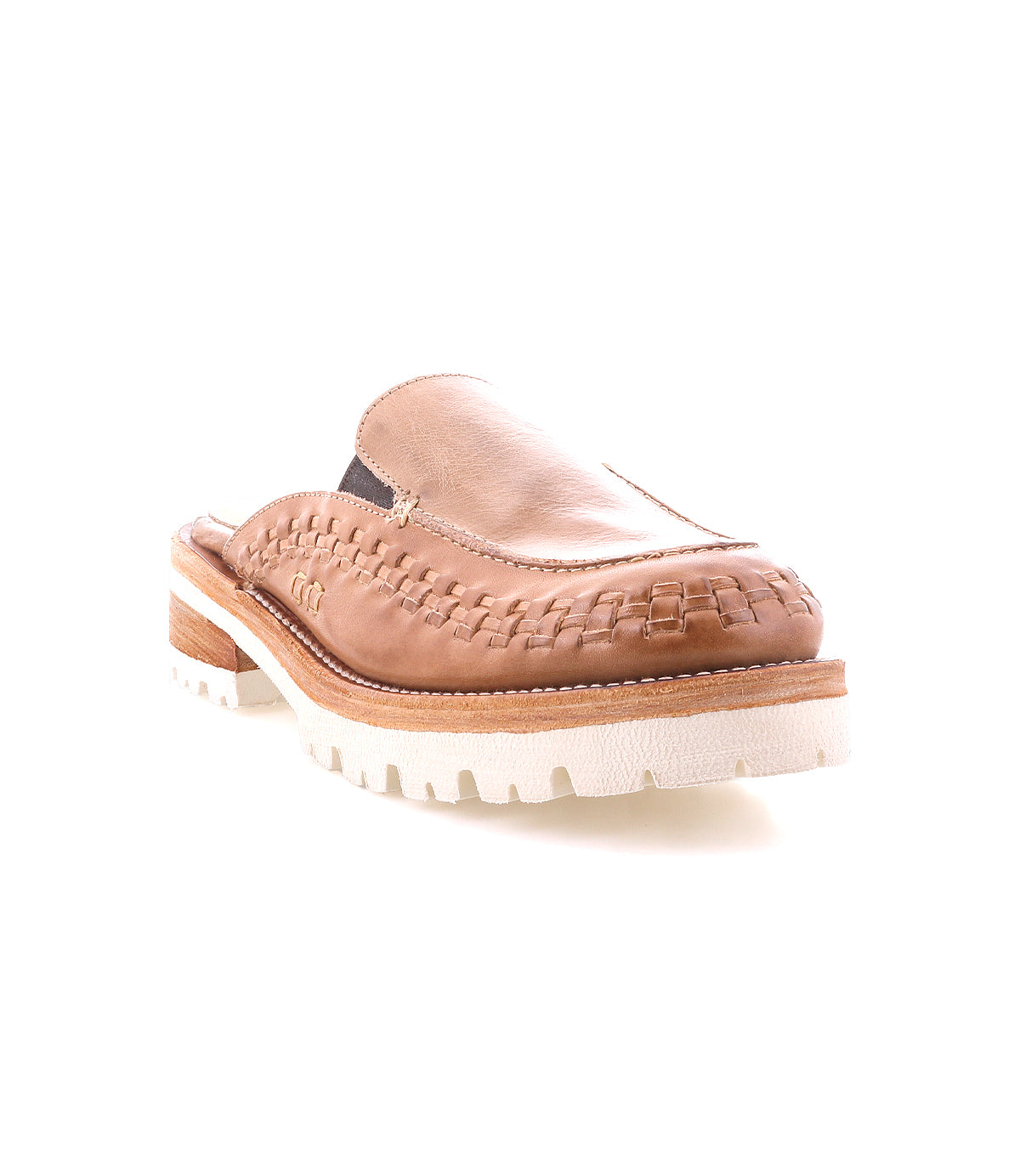 The Bed Stu Fuel is a tan handwoven leather slip-on mule featuring woven detailing, a chunky white lightweight outsole, and a low wooden heel, shown against a white background.