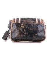 The Bed Stu Gilda is a rectangular distressed black and brown leather shoulder bag featuring dual finishes, contrasting trim, and a detachable strap, displayed against a white background.
