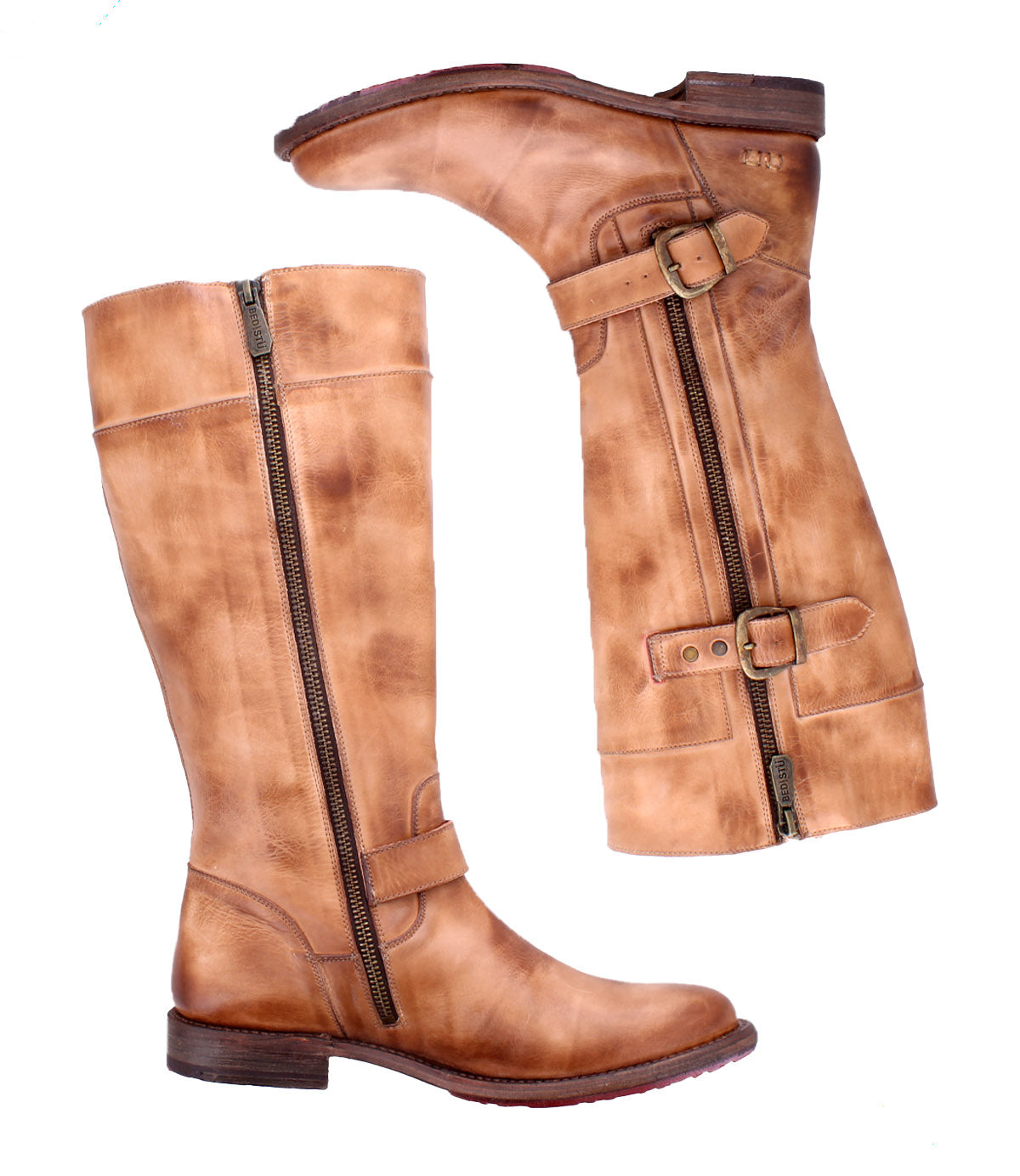 The Bed Stu Gogo Lug is a pair of tall, tan moto-style leather boots with dual zippers and decorative straps, shown from the side on a white background.