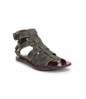 Introducing the Hera gladiator sandals by Bed Stu: a stunning brown sandal crafted from twice-tanned leather, featuring multiple straps and a secure buckle closure around the ankle. Perfect for any occasion.