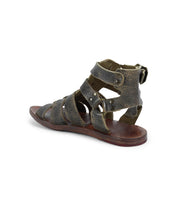 A single worn Hera sandal by Bed Stu featuring multiple dark leather straps attached to a flat leather outsole.