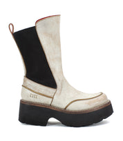 Introducing the Illicit by Bed Stu: a white and black mid-calf boot featuring a chunky black sole and a convenient pull tab at the back, perfect for adding nostalgic fashion vibes with its retro flair.
