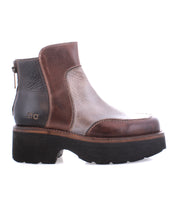 The Infamy by Bed Stu is a brown leather ankle boot with a bold look, featuring a chunky black outsole and back zipper.