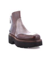 The Infamy ankle boot by Bed Stu features a brown leather design with a rugged, chunky black outsole and visible stitching that highlights its exquisite finishes.