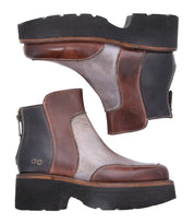 The Bed Stu Infamy is a pair of brown and gray leather ankle boots showcasing elegant leather finishes, a chunky black outsole, and stylish back zippers.