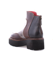 The Infamy platform boot by Bed Stu is a stylish and functional brown and black ankle boot featuring a chunky outsole and side zipper. Set against a white background, these boots provide comfortable footwear.