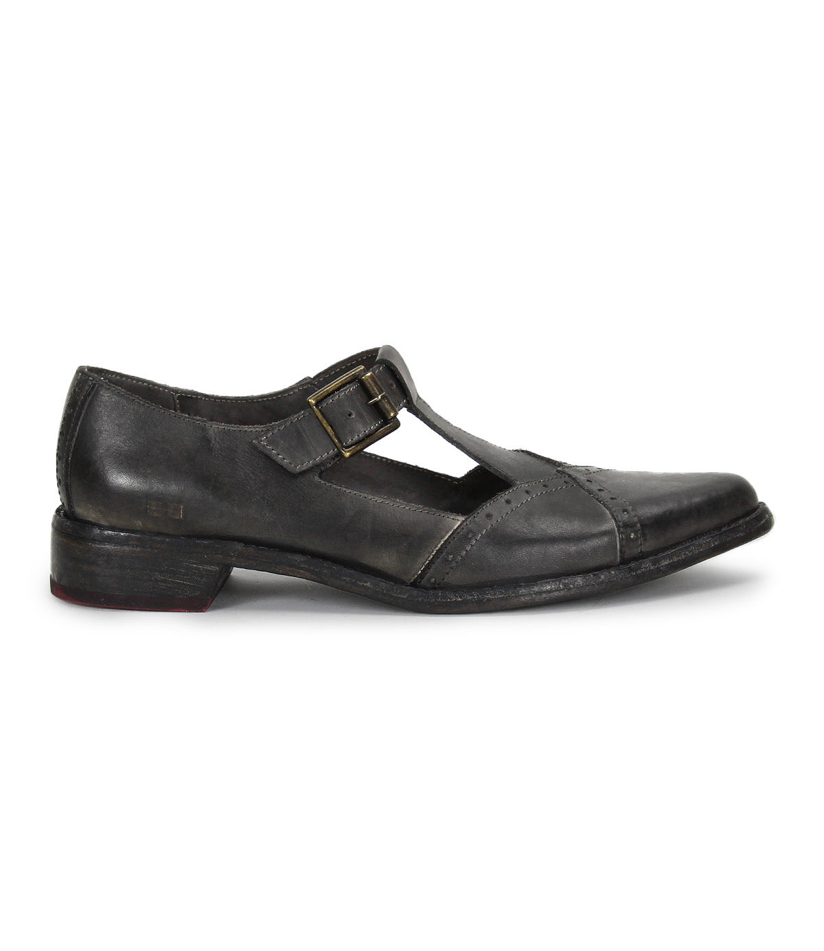 The image shows the Bed Stu "Jenny"—a single black leather T-strap shoe with a low heel, cushioned insole, side buckle, and rounded toe—displayed in profile against a white background.
