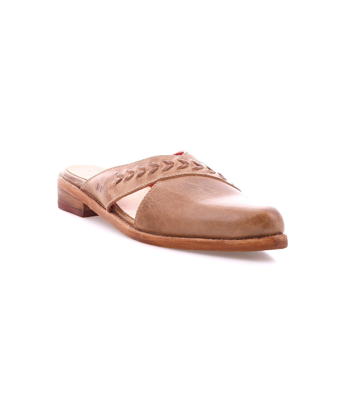 The Bed Stu Jockey is a brown leather slip-on shoe with a sleek design, low heel, decorative stitching, and subtle leather arrow inlays on the upper, shown on a white background.