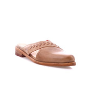 The Bed Stu Jockey is a brown leather slip-on shoe with a sleek design, low heel, decorative stitching, and subtle leather arrow inlays on the upper, shown on a white background.