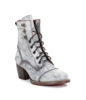 The Judgement ankle boot by Bed Stu is crafted from gray leather and showcases a lace-up design with black laces, metal eyelets, and a chunky wooden block heel.
