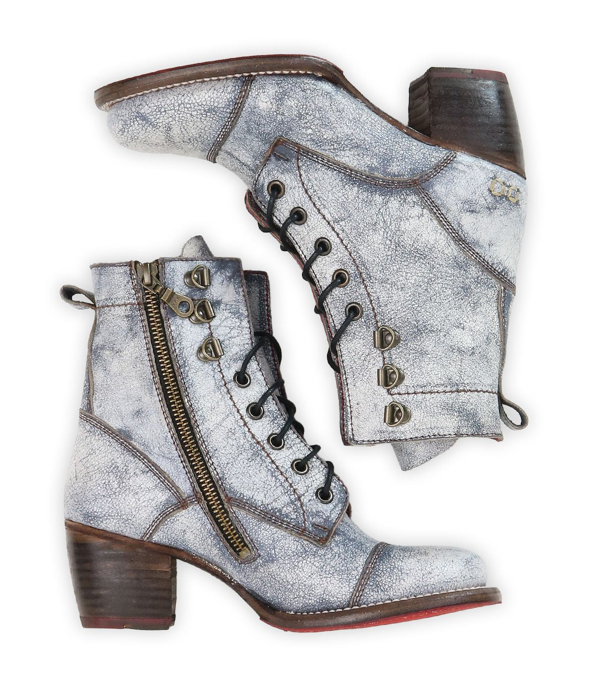 The Bed Stu Judgement boots, crafted from distressed silver leather, feature a lace-up design, zippers, and block heels arranged side by side.