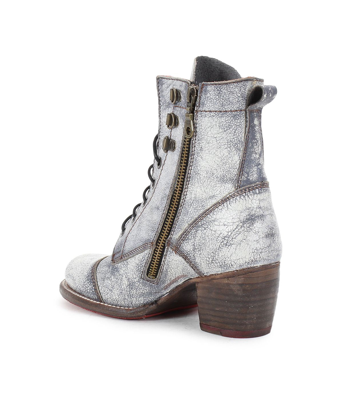 Introducing the Bed Stu Judgement boot: a silver-gray textured ankle boot with a side zipper, lace-up design, and a stylish block heel. Seen from a side and slightly rear angle, it perfectly embodies both elegance and edge.