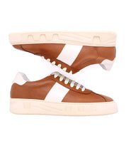 Bed Stu Law brown luxury leather sneakers with white side stripes and white soles, displayed side by side facing opposite directions, showcasing an avant-garde design.