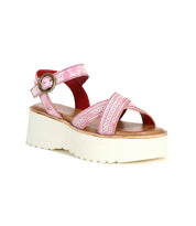 The Bed Stu Lift is a pink platform sandal featuring crisscross straps, an adjustable ankle buckle, and a thick white sole—perfect for effortless warm-weather style.