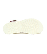 The image shows the bottom view of the Bed Stu Lift sandal in white, featuring a platform sole with a textured wavy pattern.