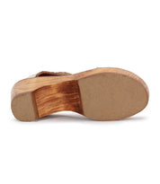 The image shows the bottom view of the Bed Stu Locket sandal, a vintage-inspired wooden heel shoe featuring a tan rubber sole with grooved texture on the heel section.