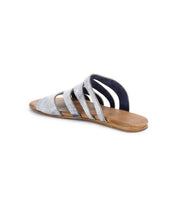 The Margin sandal by Bed Stu features a silver strappy slide design with a textured leather upper and flat brown sole, offering all-day comfort.