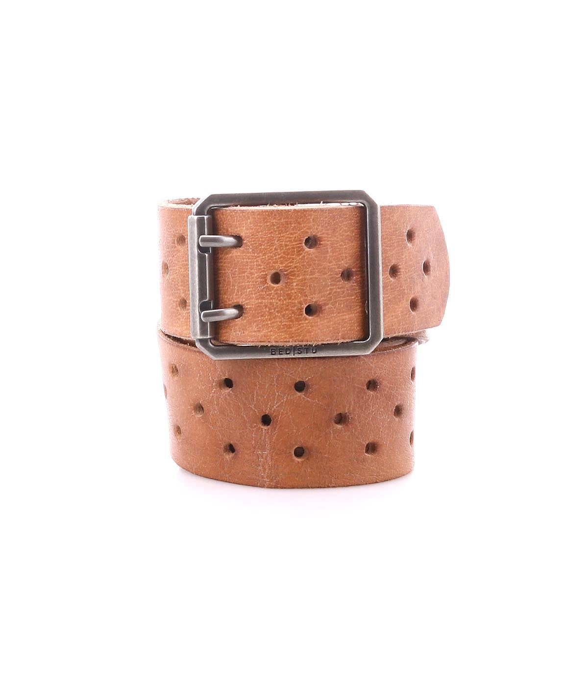 The Bed Stu Mccoy is a brown vegetable-tanned leather belt featuring a rectangular metal buckle and evenly spaced round holes, combining timeless design with modern style.