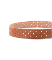 The Bed Stu Mccoy is a brown vegetable-tanned leather belt featuring evenly spaced round holes, displayed on a white background—a timeless accessory that pairs effortlessly with modern style.