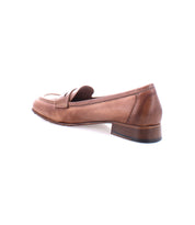 A single Paris by Bed Stu, a brown penny loafer with a low heel, crafted from Italian leather, viewed from the side against a white background.